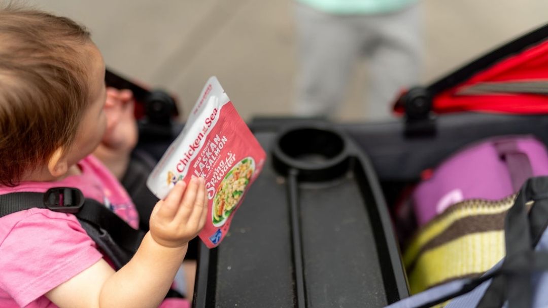 Toddler holding package of MSC certified salmon