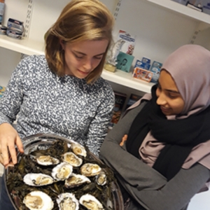 Two people looking at oyster platter