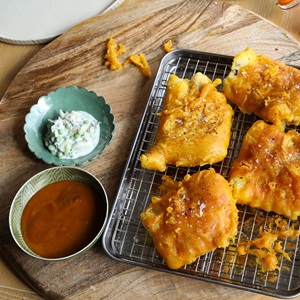 Curry-spiced beer battered cod with raita and samphire pakora