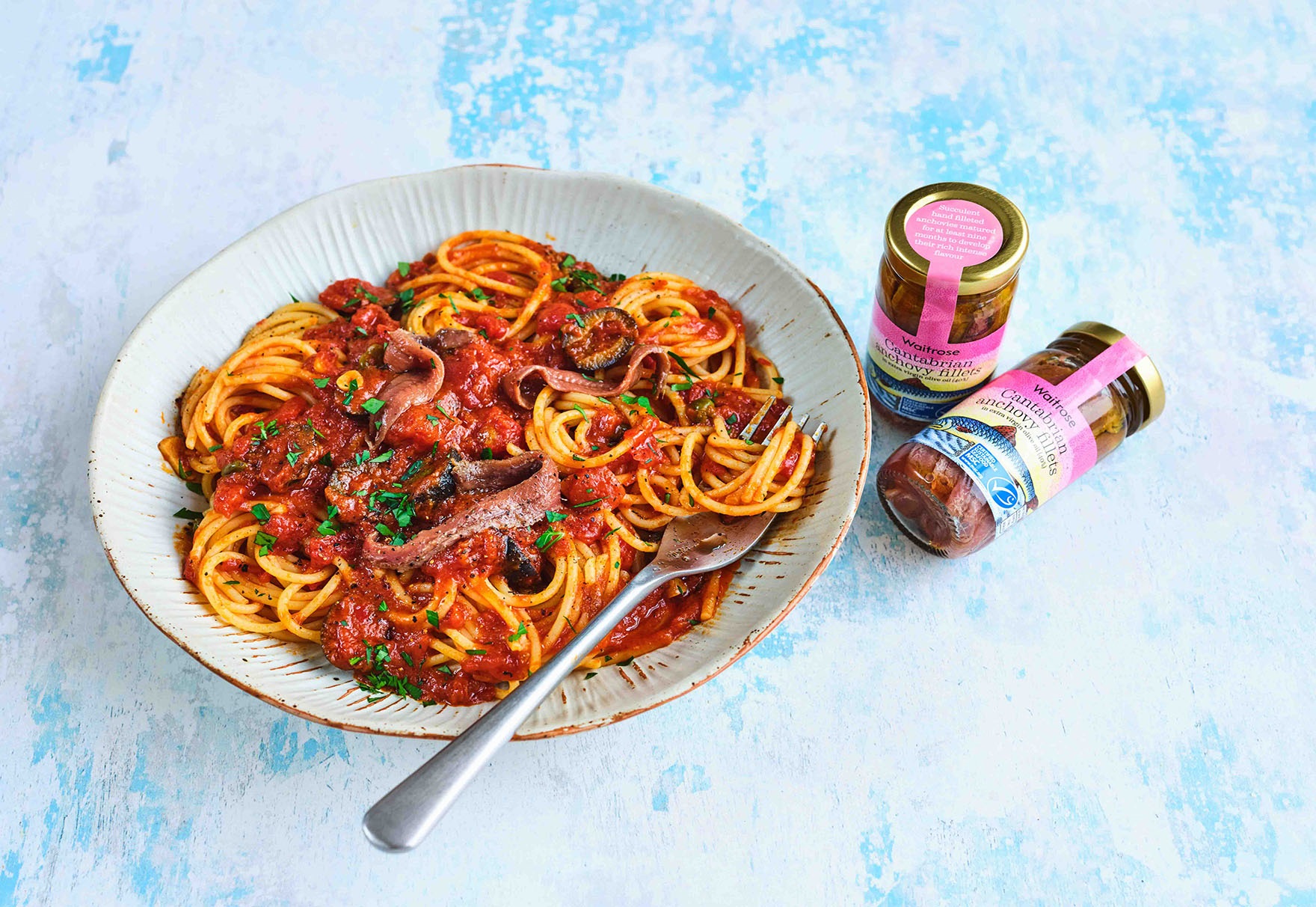 Seafood pasta with anchovy fillets on the table