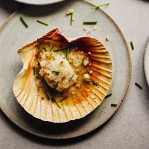 Scallops roasted in their shell with shallot and hazelnut butter