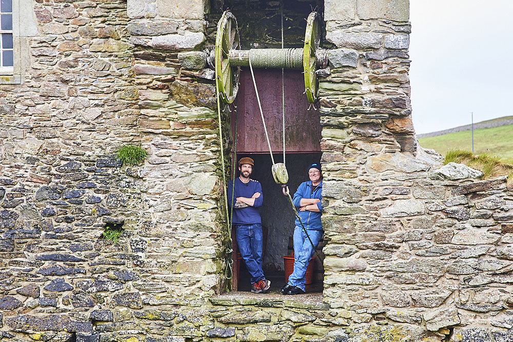 James Strawbridge and George Andrew standing in a mill