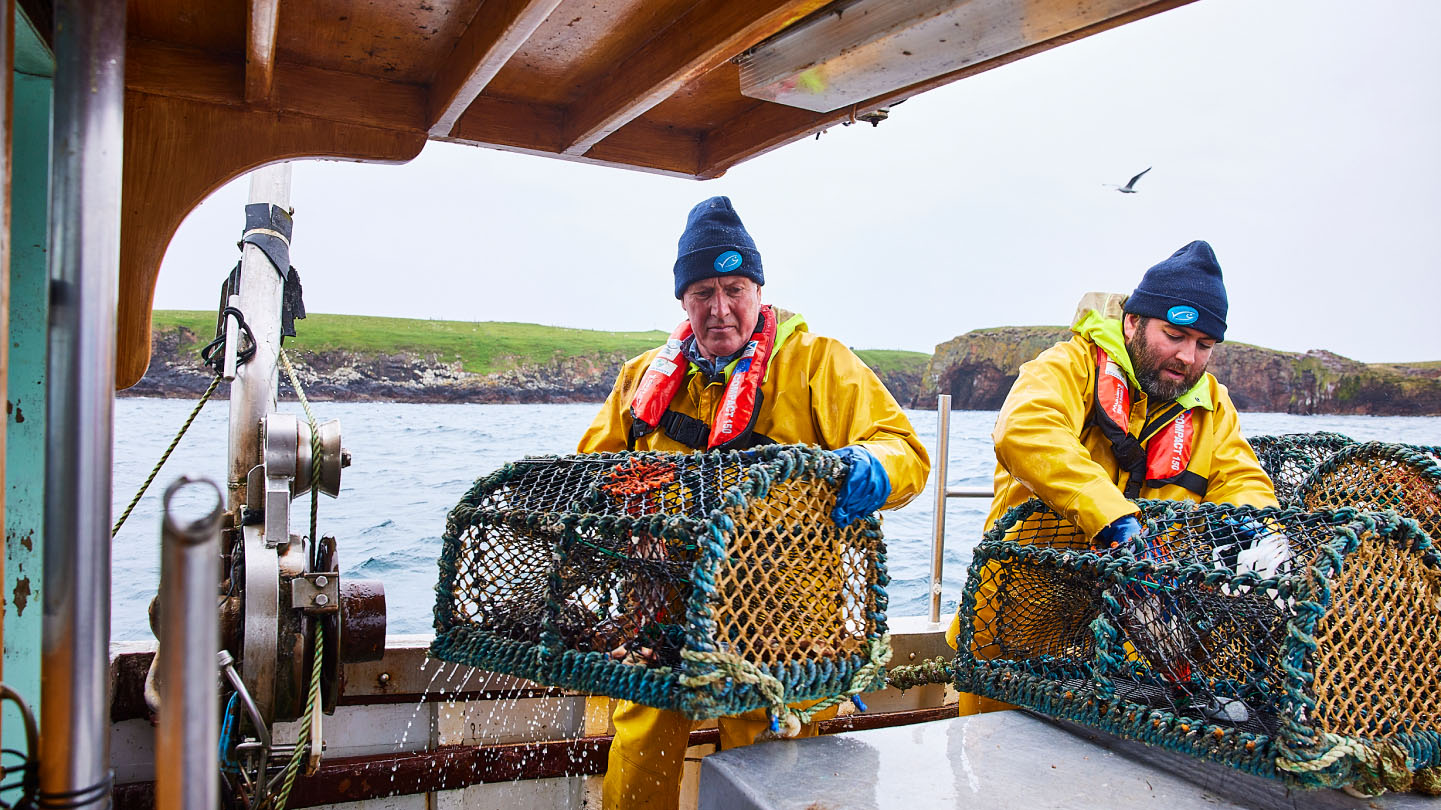 Net fishing on ship Creel pots being pulled in