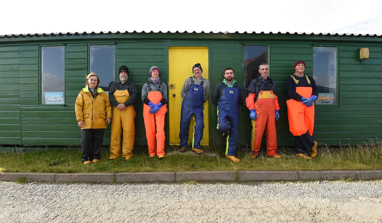Scottish mussel fishermen standing in a line